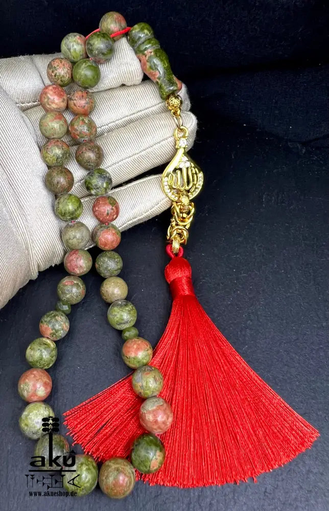 Unakit Tasbih 33 Perlen aus natürlichem Stein (10 mm) mit goldbeschichtetem 'Allah' Anhänger. Perfekt für spirituelle Energie, Meditation oder als elegantes Geschenk für besondere Anlässe