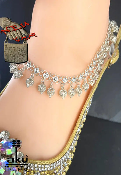 Detailaufnahme eines indischen 925er Silber-Fußkettchens mit Glöckchenanhängern am Knöchel getragen – traditioneller Schmuck mit filigraner Verarbeitung. 